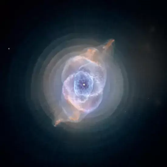 The Cat's Eye Nebula: A captivating image of the Cat's Eye Nebula, a celestial phenomenon showcasing intricate layers of gases and cosmic colors, illustrating the magnificence of the universe's vastness.