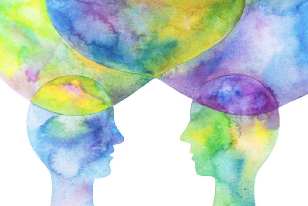 A vibrant painting featuring the silhouettes of two people looking at each other, capturing the theme of interpersonal relationships, misunderstandings, and energy management discussed in this blog section.